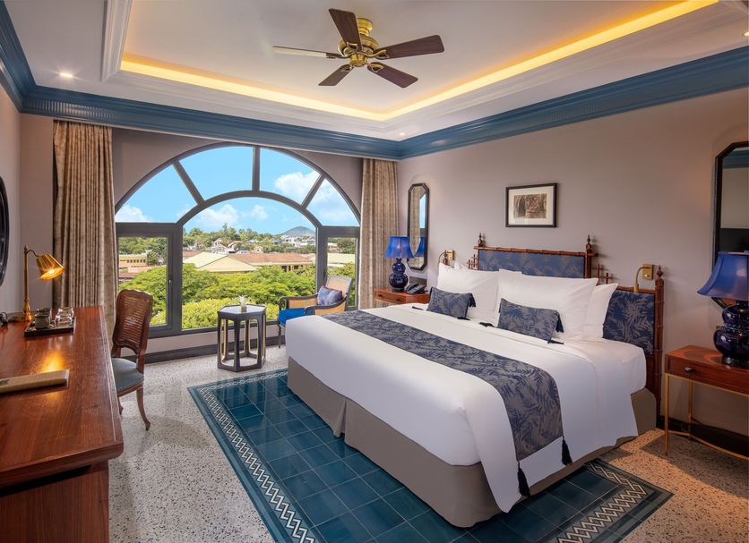 Silk Path Grand Hue Hotel room with large arched window and city views in Hue