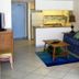 Islander Beach Resort New Smyrna Beach living area with sofa, chair, coffee table and kitchen