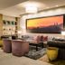 Anew Hotel Hatfield Pretoria lounge with sofa, armchairs and framed sunset city art in Pretoria