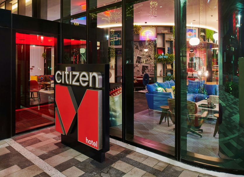 citizenM Miami World Center hotel entrance in Miami with glass walls and modern lounge seating