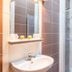 Hotel - Restaurant du Lac - Agen bathroom with sink, shower and tiled walls in Boé