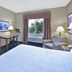 Hampton Inn Pittsburgh Area-Beaver Valley-Ctr Township Monaca guest room with bed, TV, desk, window and armchair