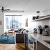 Mint House Dallas Downtown By Kasa suite with city skyline view, sofa, coffee table, and kitchenette in Dallas