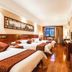 Sanqingshan Jinshawan Holiday Hotel Shangrao room with three beds, wood floor, and window view