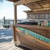 Surf & Sand Hotel Pensacola Beach beachfront tiki bar with dockside seating and ocean view