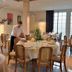 Logis Auberge des Vieux Chênes in La Chapelle-aux-Brocs dining room with set tables and a server