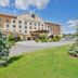 Comfort Suites Airport Tukwila Seattle exterior with landscaped lawn and covered entrance in Tukwila