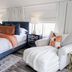 The Evers House in Fredericksburg: stylish guest room with king bed, lounge chair, and bedside lamp