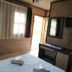 Seven Rock Cave Hotel in Göreme room with bed, TV, mirror, and open door to outside light