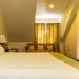 Elite Hotel, Port Au Prince: guest room with bed, seating nook, and window curtains