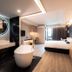 56 Hotel in Bangkok room with freestanding tub, king bed, vanity and floor-to-ceiling window