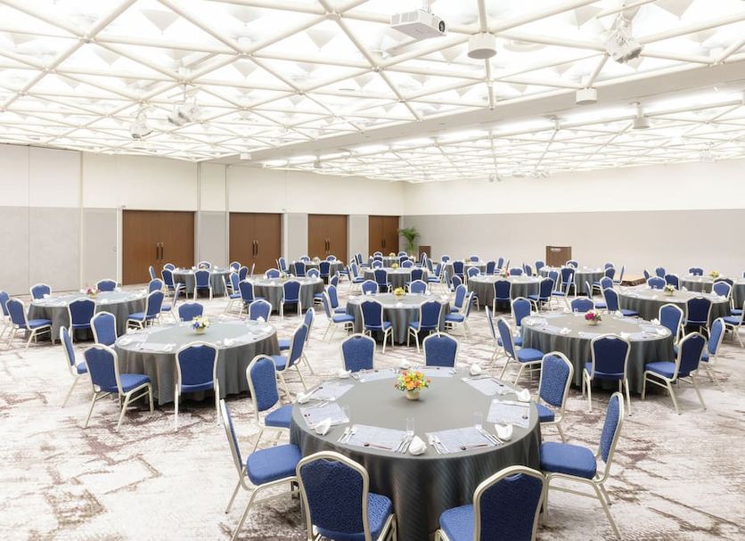 Art Hotel Niigata Station banquet hall with round tables and blue chairs in Niigata