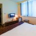 Atour Hotel Dalian Zhongshan Plaza guest room with bed, wall-mounted TV and large window in Dalian