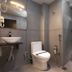 Grande Inn, Tiruchirappalli: compact modern bathroom with toilet, sink, shower and towel rack