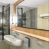 Campanile Nature - Cahors bathroom with bathtub, sink, and large mirror