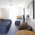 Tocumwal Golf Resort room in Tocumwal with three beds, TV, ceiling fan and bright window light