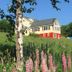 Pension Hoshi Ni Negaiwo in Furano, hillside guesthouse with colorful wildflowers and trees