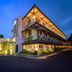 Hotel Nyland Pasteur Bandung exterior at dusk in Bandung with illuminated balcony and landscaped entrance