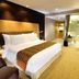 Swiss-Belhotel Mangga Besar Jakarta guest room with king bed and glass-walled bathroom