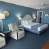 Shoreline Island Resort - Exclusively Adult guest room in Madeira Beach with king bed, recliners and blue walls