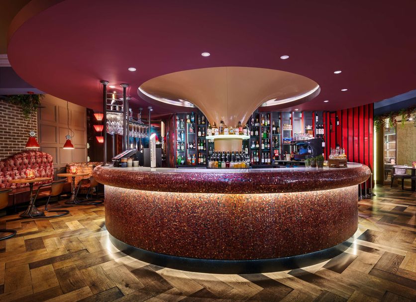 Cairn Hotel Newcastle Jesmond bar with curved counter and colorful lounge in Newcastle upon Tyne