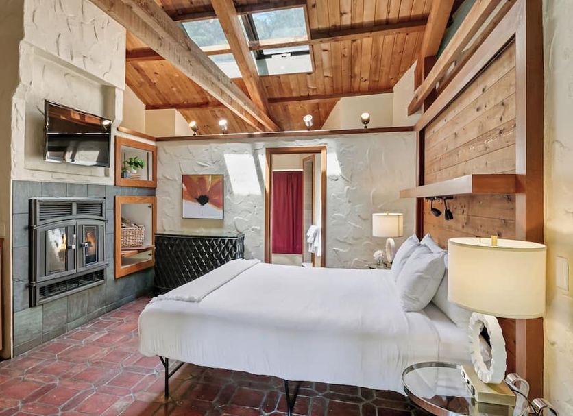 Sonoma Coast Villa room in Bodega with fireplace, wood-beam ceiling, and skylight