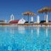 Margie Mykonos Hotel in Mykonos with rooftop pool, sun loungers and thatched umbrellas
