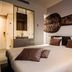 Golden Tulip Leiden Centre room with double bed, modern wall art and bathroom window in Leiden