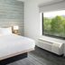 TownePlace Suites by Marriott Pigeon Forge guest room with bed and large window view