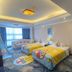 White Dolphin Hotel in Qinzhou guest room with two beds, colorful bedding, sofa, and ocean-themed rug