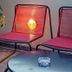 City Circus Athens lounge seating with two pink chairs, potted tree, and glass ashtray in Athens