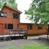 Cabañas Bordenieve in Termas de Chillan, wooden cabin lodge with deck and surrounding trees