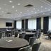 Meeting room at Portsmouth Marriott Hotel in Portsmouth with round tables and chairs under recessed ceiling lights