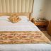 Shangmao International Hotel in Nanjing guest room with king bed, bedside tables and patterned throw
