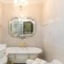 Casa Nostra Boutique Hotel Paraty bathroom with clawfoot tub, ornate mirror and gold accents