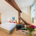 Tailormade Hotel Rüden Schaffhausen room with exposed beam, bed, and seating area
