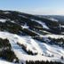 Snow-covered ski slopes and forested mountains near Hafjell Hotell in Øyer (Hafjell)