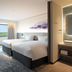 Grand Mercure Nasu Highlands Resort & Spa room with two beds and window view of green hills in Nasu