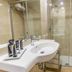 Eix Alcudia Hotel +18 bathroom with glass walk-in shower, sink, and beige tile walls in Alcúdia