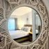 4145 By The Sea Inn & Suites room with rope-framed mirror reflecting a bed in Lauderdale-by-the-Sea