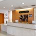 Front desk at HOTEL AZ Fukuoka Amagi Inter in Asakura with wood-paneled reception and granite counter