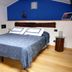 Affittacamere Da Cesare in Monterosso al Mare bedroom with blue accent wall and double bed