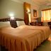 Hotel City Tower Coimbatore guest room with twin beds, window light, and desk area