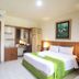 Mirah Hotel & Resort Banyuwangi room with king bed, desk, wall TV and air conditioning