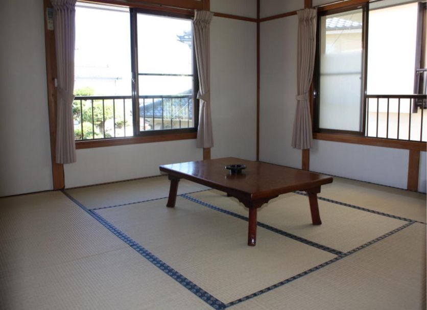 Minshuku Hayashi in Kamogawa tatami room with low table and windows