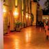 Heritage By Serendib in Blantyre with a warmly lit outdoor terrace and dining tables at night