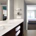 Residence Inn by Marriott Salt Lake City-West Jordan bathroom with walk-in shower and view into bedroom