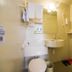 Hi Inn Beijing Shangdi Anningzhuang bathroom with toilet, sink, mirror, shower hose and towels