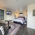Eo Bungalows, Black Hills in Custer room with bed, sofa, round table and wall-mounted TV