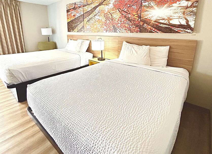 Days Inn by Wyndham Lake Park/Valdosta guest room with two beds and autumn wall art
